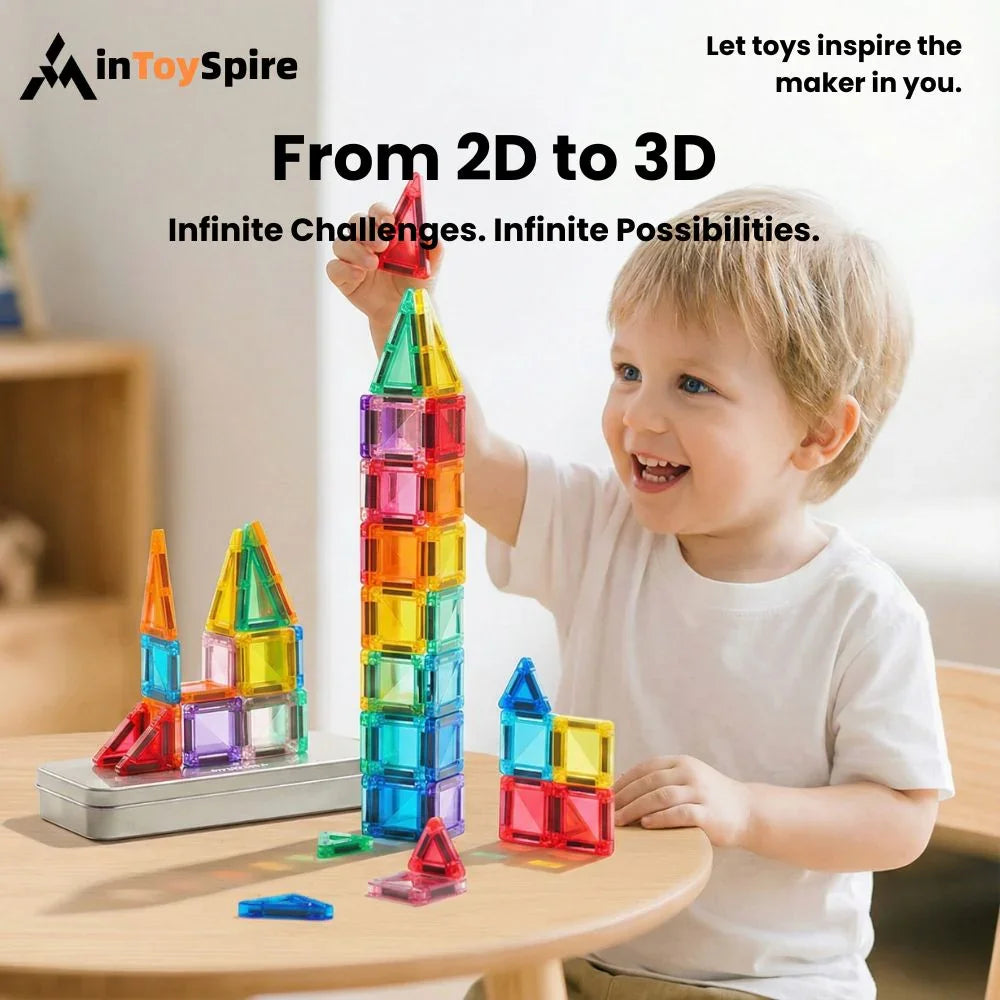Young boy happily building colorful 3D tower with translucent magnetic toy blocks on wooden table