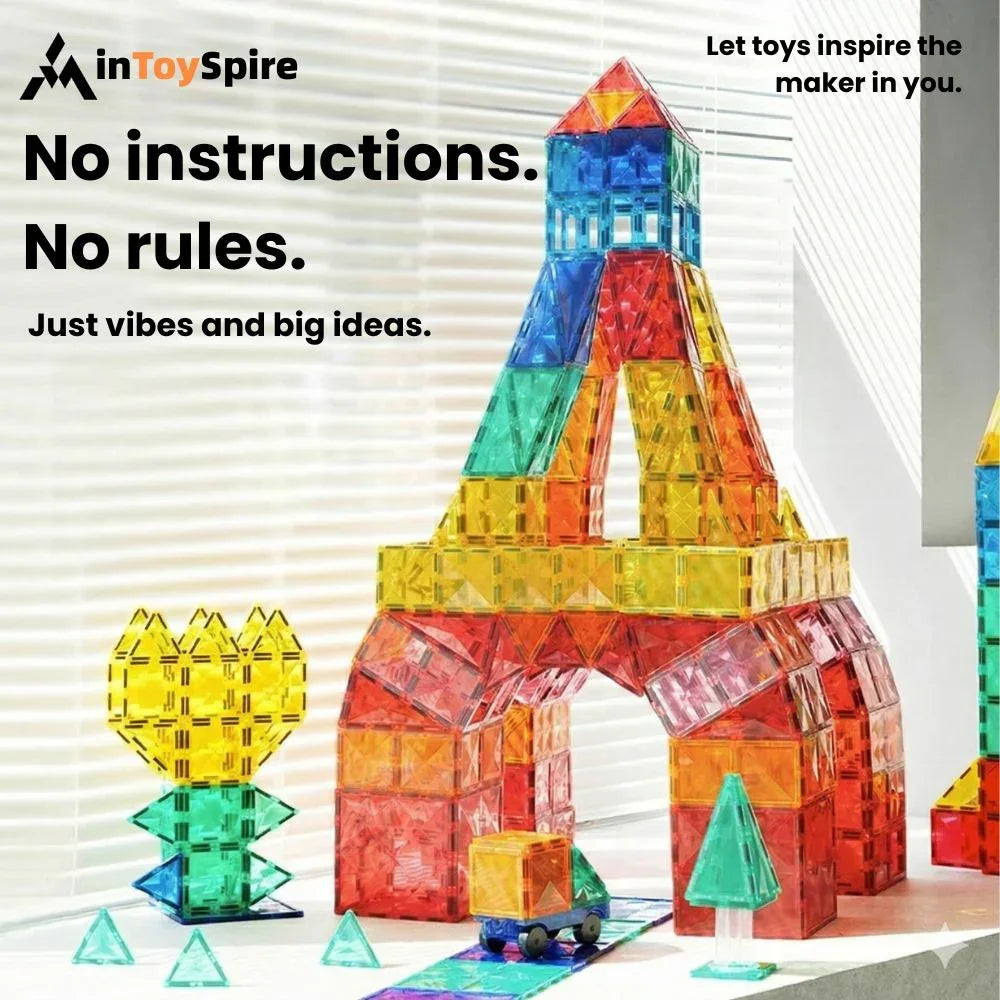 Colorful stained glass magnetic tiles shaped into a tower, flower, tree, and toy truck on a windowsill